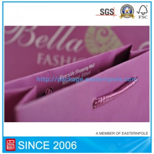 كيس من الورق الأرجواني مع مقبض معقود